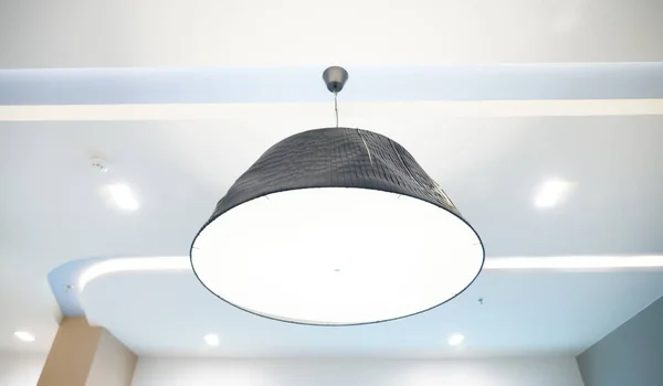 Hanging lamp from ceiling in office background
