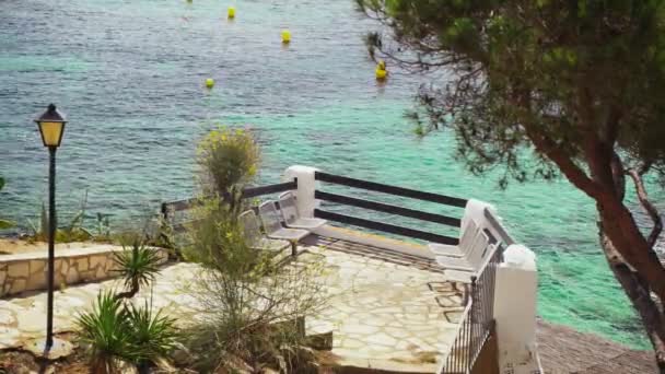 Küçük bir Akdeniz kasabasında güzel bir gezinti manzarası. Köy, göz kamaştırıcı zümrüt körfezinin kıyısında. Deniz kenarında güneşli bir yaz günü. Sahilde tatiller. Resimli tekne parkı... — Stok video
