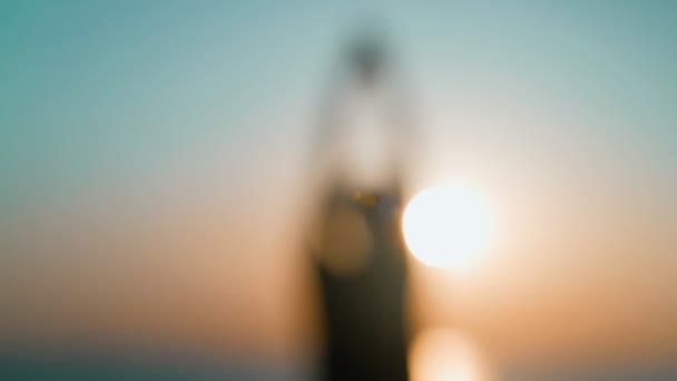 Morning workout. Warm up and stretching before training on the sea pier. Young man practicing youga against the backdrop of the sea and the rising sun. Sport activity. Athlete silhouette. — Stock Video