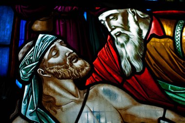 The story of the caring and compassionate Samaritan in the Bible is well-known to Christianity. The caring Samaritan will always be an example of God's love and care for mankind. This is a stain glass painting in an old church in Thornhill (Scotland) clipart