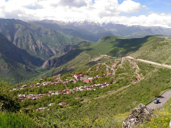 アルメニアのコーカサス山脈 深い峡谷 Harsnadzor 道路があるエッジに沿って 緑豊かな植生で覆われています 小さな村 雲と青空 — ストック写真