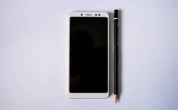 pen and notebook white phone