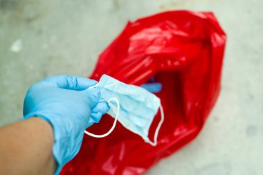 Biyolojik risk atığı hastanedeki kırmızı çöp torbasına atıldı, cerrahi maske, kapalı el.