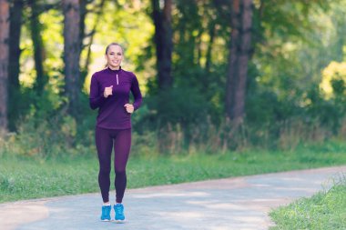 Çalışan kadın. Kadın atlet açık havada parkta koşu. Fitness, spor ve ağırlık kaybı kavramı