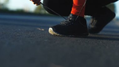  Erkek atlet yolda koşu için bağcık bağlama 