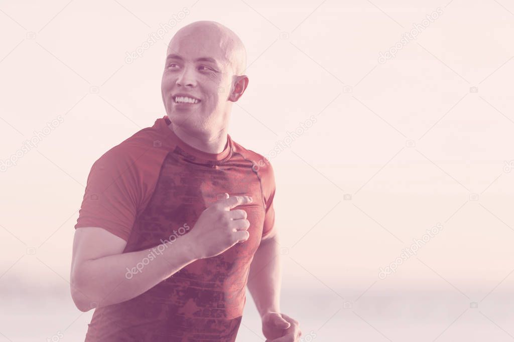 Happy athletic man jogging outdoors. Healthy lifestyle, fitness, sport and weight loss concept