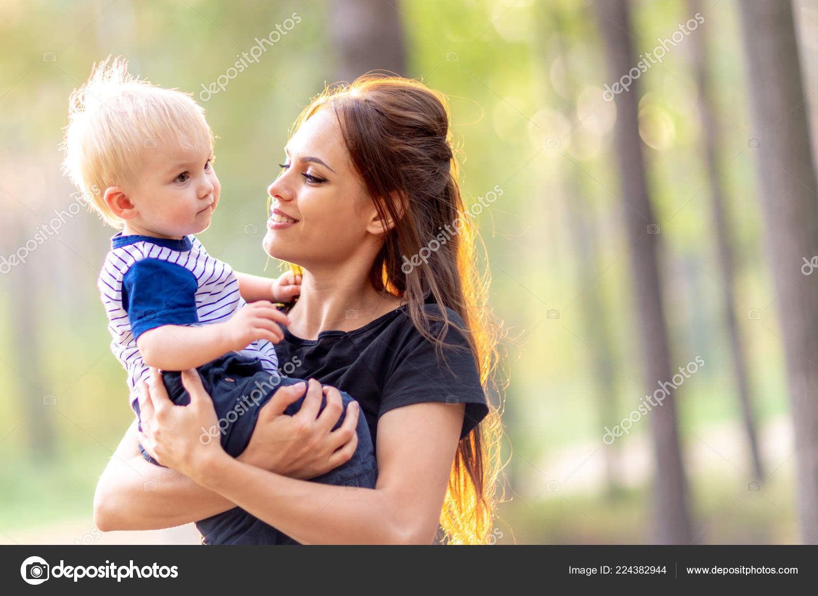 Mom and baby together. Young mother hugs son. Woman with a ...