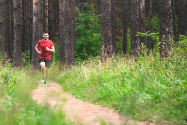 Çalışan adam. Parkta koşu Erkek atlet. Adam eğitim açık havada. Orman yolu üzerinde egzersiz. Sağlıklı, fitness, sağlıklı yaşam yaşam tarzı. Spor, kalbî, egzersiz kavramı