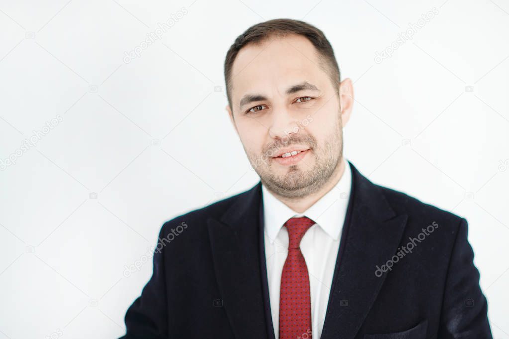 Confident businessman smiling on isolated background.