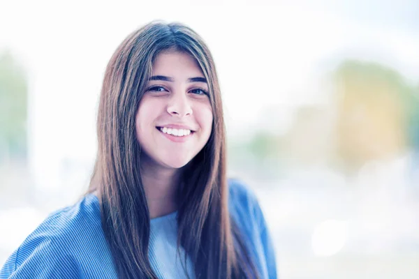 Smiling girl with thick eyebrows