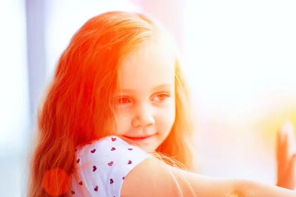 Beautiful little girl near the window — Stock Photo, Image