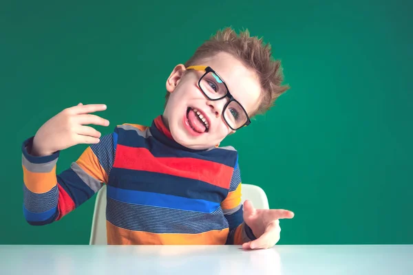 Cheerful boy with glasses shows tongue. Playful mood. Close-up — Stock Photo, Image