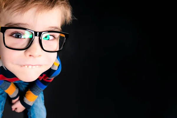 Funny boy in glasses, looks at the camera from the bottom up. Cl — Stock Photo, Image