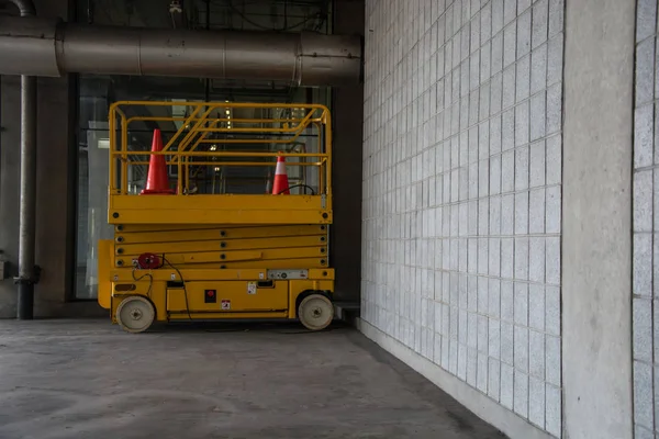 distribution warehouse hall with hydraulic scissors lift platform