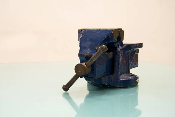 Blue steel vise on table background — Stock Photo, Image