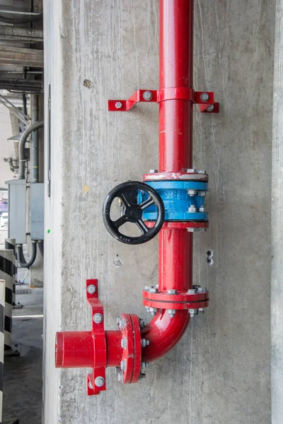 Red gas pipe with blue valve — Stock Photo, Image