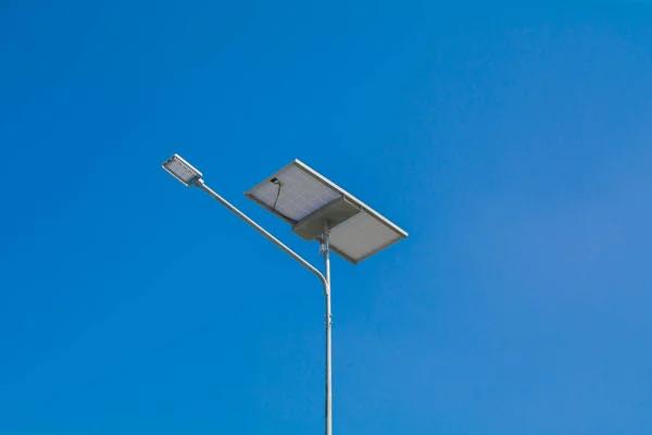 LED street light with solar cell on clear sky, closeup view.