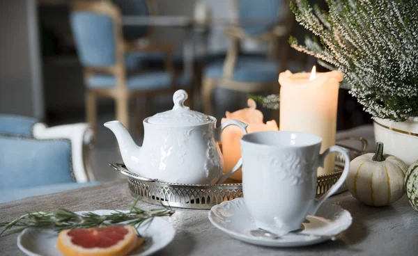 Evening tea with rosemary and grapefruit, by candlelight in a vintage cafe