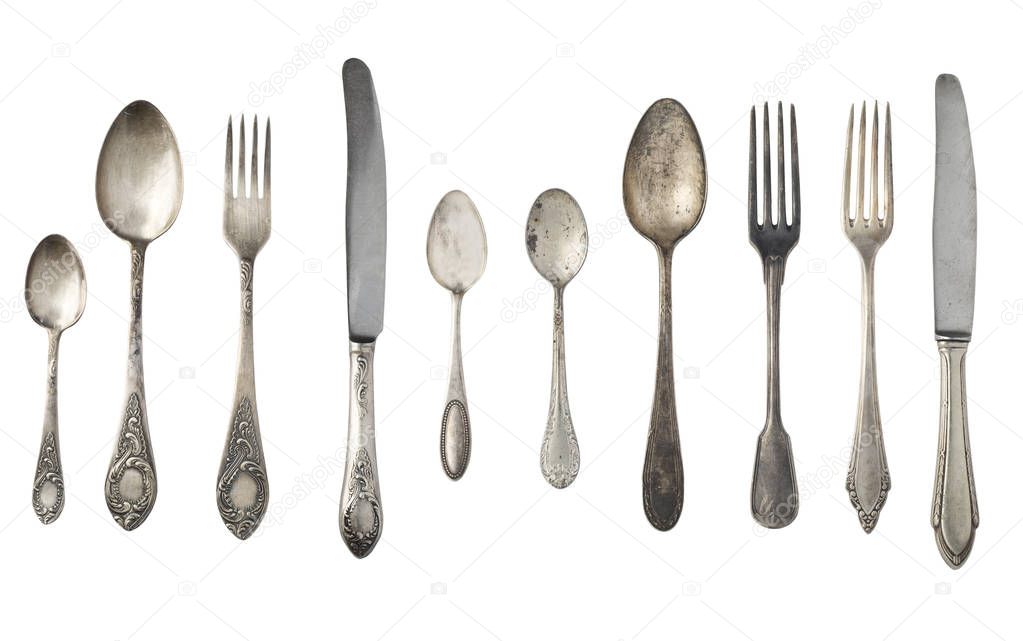 Vintage spoons, forks and knives isolated on a white background. Retro silverware.