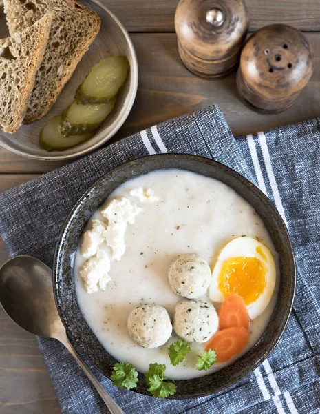 A plate with white Polish soup. White borsch with egg, meatballs — Stock Photo, Image