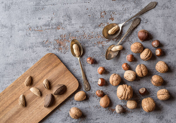 Nuts on a beautiful background and vintage spoons. Background to