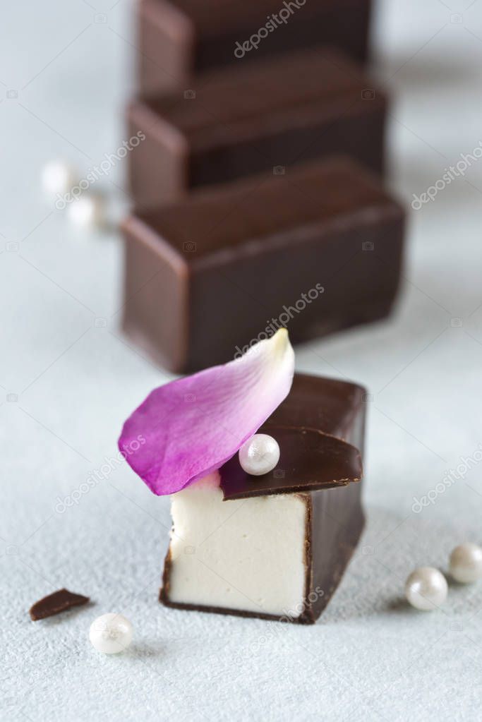 Candy Bird's milk in chocolate. Rose petal and sugar pearls
