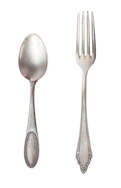 Vintage tea spoon and fork isolated on a white background. Retro