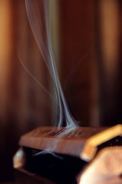 The photo shows a case with incense. Smoke rises from the case. Camera model Canon EOS 600D. Aperture f/5.6. Shutter speed 1/60 s. The focal length 79 mm