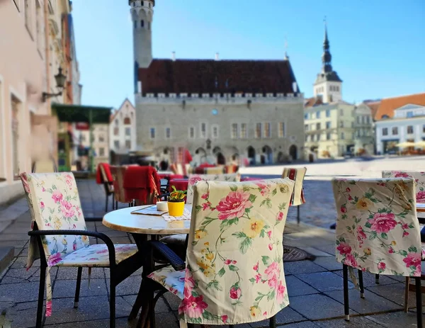 Street Cafe tables and chair   in the city waiting People  for relax  and have cup of coffee travel to Europa Baltic Old Town Of Tallinn Estonia Sunny Afternoon on Town Square travelling to Europa