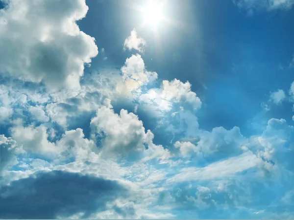 blue sky fluffy clouds and sunlight beams skyline  nature landscape weather forecast