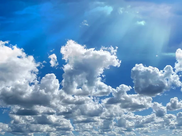 blue sky fluffy clouds and sunlight beams skyline  nature landscape weather forecast