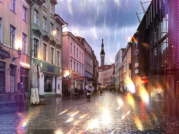 rainy city people walk with umbrellas wet pavement medieval house evening light blurred light  in Tallinn old town Estonia  rainy weather   rainy weather