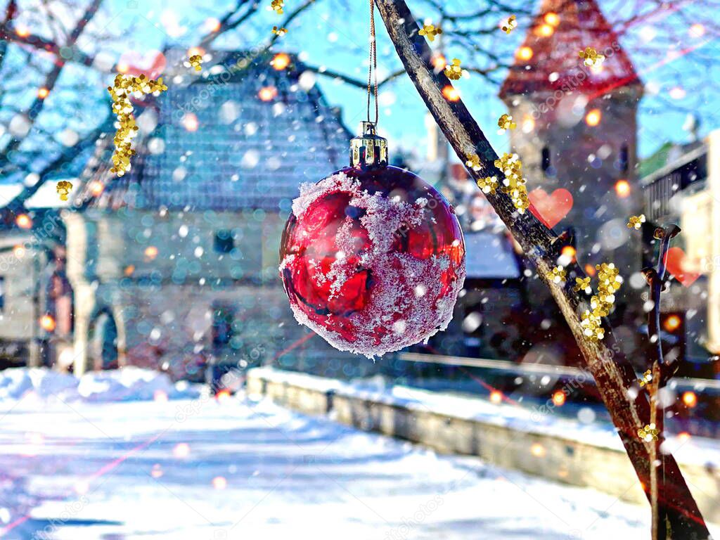 Christmas red ball and snowflakes on tree at city park in medieval old Town of Tallinn holiday winter travel to Estonia 