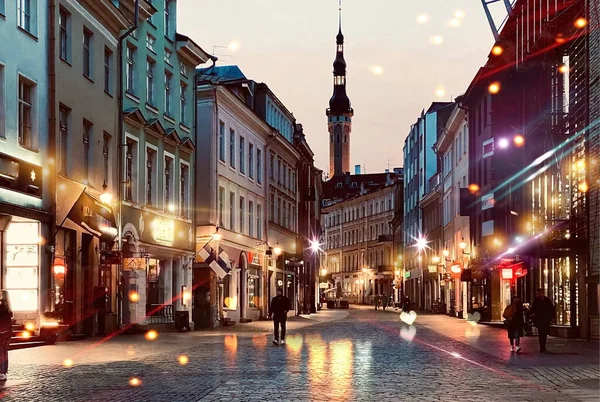  Tallinn 'de Sonbahar Akşamı Ortaçağ şehrinde insanlar yürür ve dinlenir. Gece lambaları Estonya' ya yapılan kaldırım yolculuğunda bulanıklaşır. 