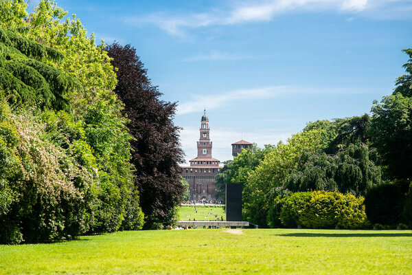 Sempione Park (Parco Sempione) in Milan, Italy. Sforza Castle. Filarete Tower. Blue Sky. Sunny Day.