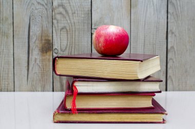 Beyaz bir arka plan üzerinde apple ile eski kitaplar.