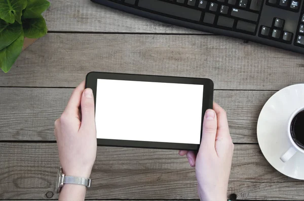 Dijital tablet ile boş perde ahşap bir masa üzerinde tutan eller kadın.