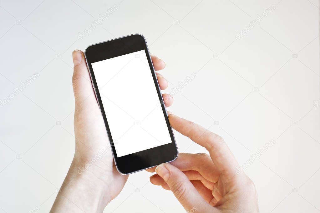 Woman hand holding black smartphone with blank screen, isolated on white background.