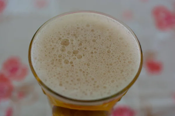 a new filled glass of beer, frothy. drink ready to drink