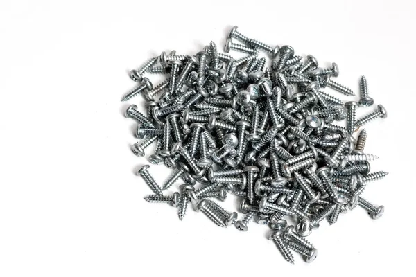 Small Stainless Steel Screws Piled White Paper Isolate — Stock Photo, Image