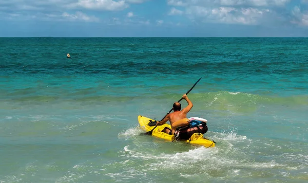 Lifeguard floats in a kayak to rescue  man — Stock Photo, Image