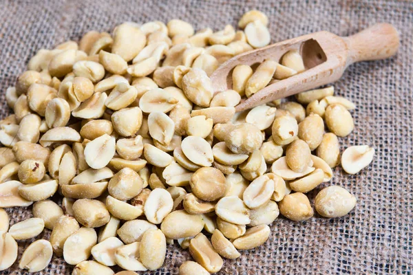 Soyulmuş fıstık ve ahşap kepçeler çuvalüzerinde