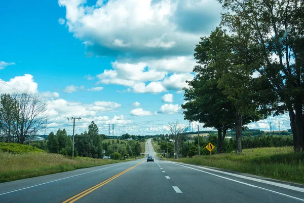 野原のパノラマビューを望む道路 ロイヤリティフリーのストック写真