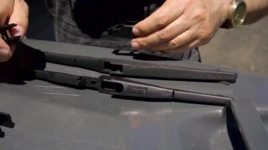 Yolcu arabası sürücüsü eski silecekleri yenileriyle değiştiriyor.