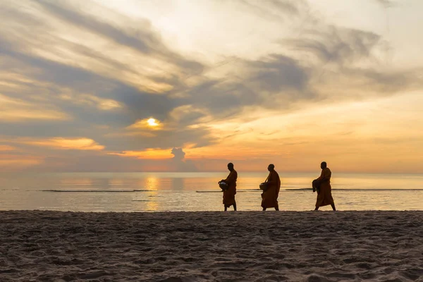 Three monks are walking on beach — Stock Photo, Image