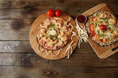 İki deniz ürünleri pizza, metin için yer bir ahşap rustik masada karides ve mozzarella peyniri