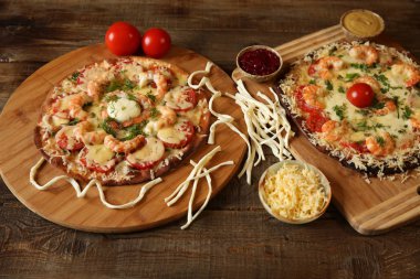 İki deniz ürünleri pizza, metin için yer bir ahşap rustik masada karides ve mozzarella peyniri