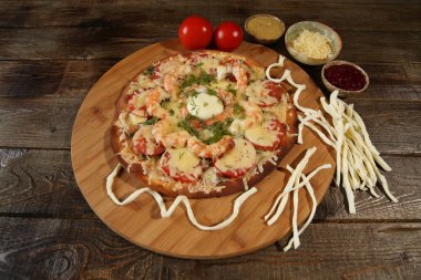 Ahşap rustik bir masada deniz ürünleri pizza, karides ve mozzarella peyniri