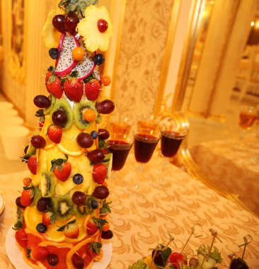  taze meyve ve çilek kırmızı şarap ve şampanya ile bir tabloda Piramidi