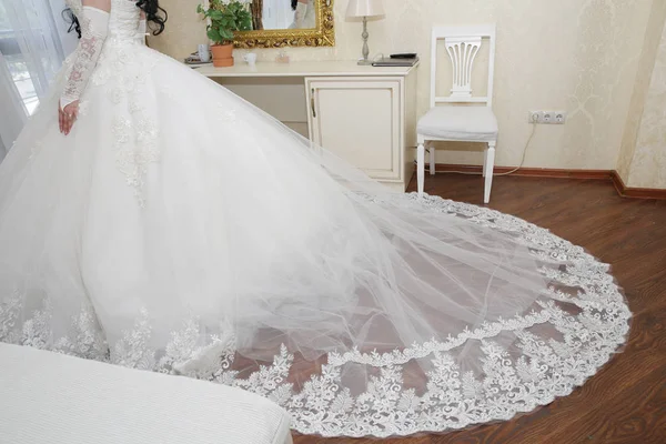 bride in a white wedding dress with lace and a long train